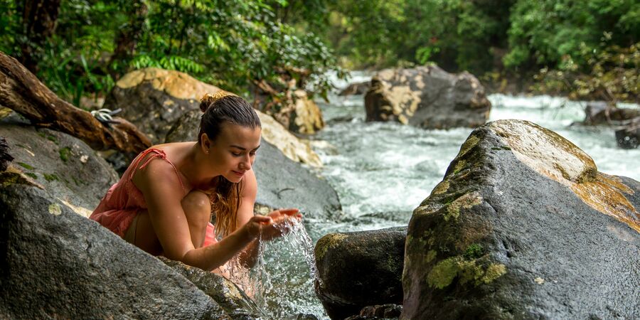 woman drinking creek